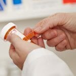 Pharmacist applying a drug warning label.  Please see my portfolio for other medical and pharmaceutical related images.